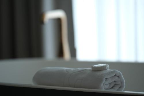 a white towel sitting on top of a table at Quinta da Maquia Hotel in Sintra