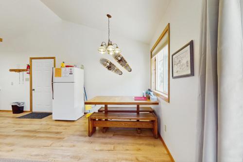a kitchen with a table and a refrigerator at Elephant Mountain Cabin at Filoha Meadows in Redstone