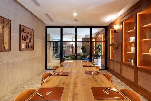 a long wooden table in a room with chairs at Atocha Hotel Madrid, Tapestry Collection by Hilton in Madrid