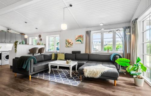 a living room with a couch and a table at Holiday Home Linningvej in Hemmet