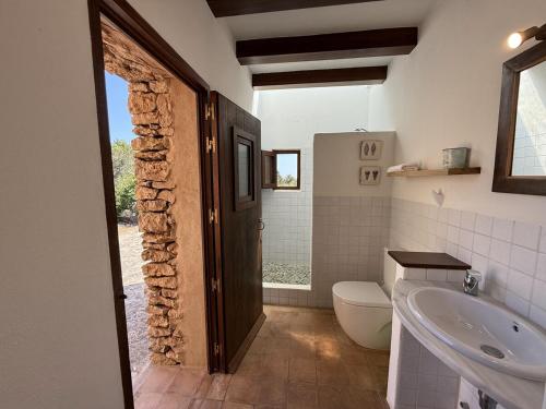a bathroom with a sink and a toilet and a tub at Ca Na Vilda in Sant Ferran de Ses Roques