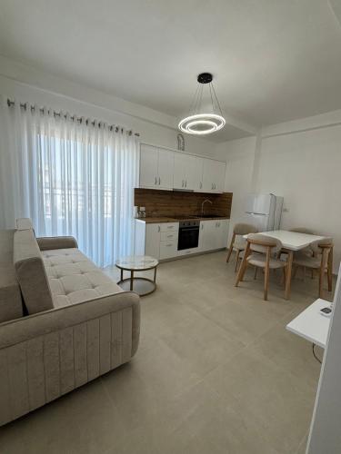 a living room with a couch and a table at AP Apartments Golem in Golem