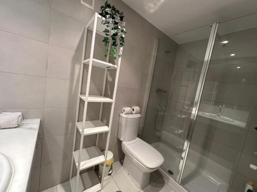 a white bathroom with a toilet and a shower at Lujoso Loft La Moraleja in Madrid