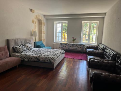 a living room with a bed and a couch at Bordeaux Castle natural No2 in Quinsac