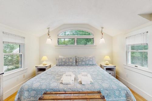 a bedroom with a large bed with two tables at Gingerbread Dream in Oak Bluffs