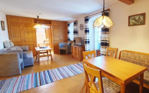 a living room with a table and a dining room at Hechlhof in Seeon-Seebruck