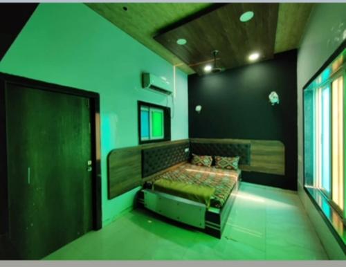 a bedroom with a bed in a room with green walls at Luxury villa in Mumbai