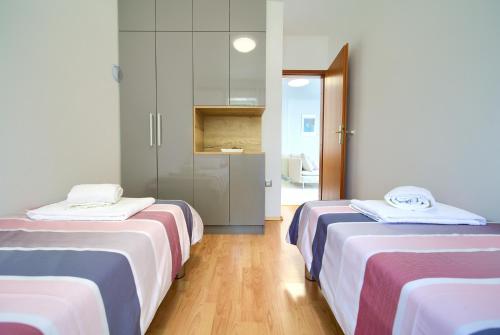 Katil atau katil-katil dalam bilik di Apartmani Alta