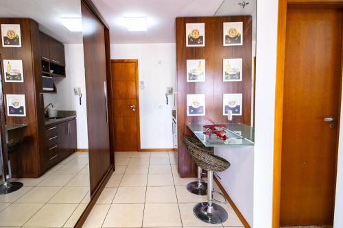 a room with a hallway with a mirror and a chair at OZPED Flats Particulares Edifício Life Resort in Brasilia