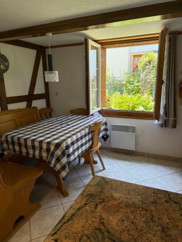 a dining room with a table and a window at Casa Walser Quarten - CharmingStay in Quarten