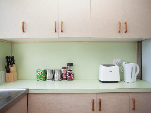 a kitchen counter with a toaster and other appliances on it at CBD Holiday Home in Mackay