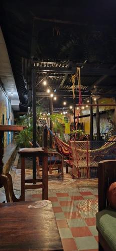 a patio with hammocks and swings in a restaurant at White Rabbit Hostal in Granada