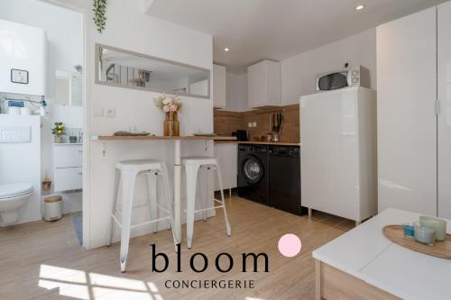 a kitchen with white cabinets and a white refrigerator at Le Diamant tout équipé de la Vieille Ville in Nancy