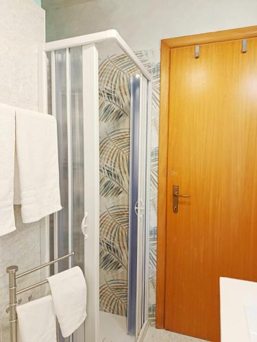 a shower with a glass door in a bathroom at PIAZZA SANTANGELO - Home - in Busso