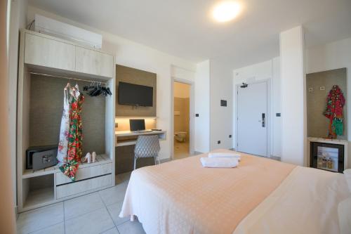 a bedroom with a bed and a desk at Hotel Graziella in Martinsicuro