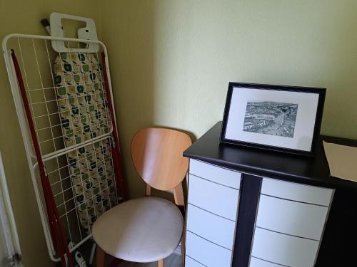 a desk with a chair and a picture on it at Rahu34 in Jõhvi