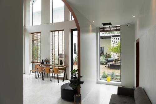 an open living room with a table and chairs at Bali hotel 