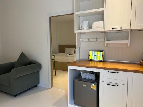 a kitchen with a counter and a chair and a room at Bali hotel 