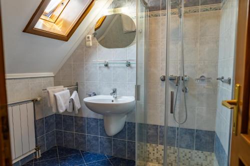 a bathroom with a sink and a shower at Friskó Panzió in Zalakaros