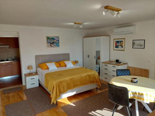 a bedroom with a bed and a table in it at Apartment Nona in Korčula