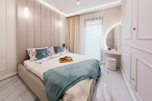 a bedroom with a bed with a tray on it at Sea Shell Stadium Brzeźno Beach in Gdańsk