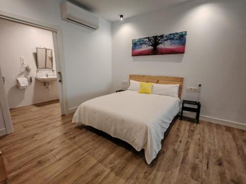 a bedroom with a bed and a sink in it at Bilbao ROOMS & KITCHEN Rekalde in Bilbao