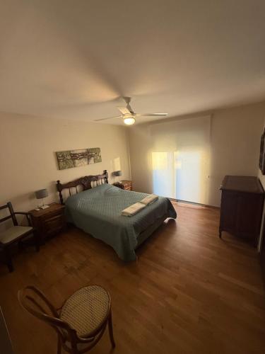 ein Schlafzimmer mit einem Bett und einem Stuhl darin in der Unterkunft Departamento en Santiago del Estero 2 dormitorios in Santiago del Estero