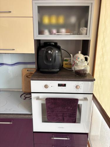 a kitchen with a microwave on top of a stove at Villa Amity in Varna City
