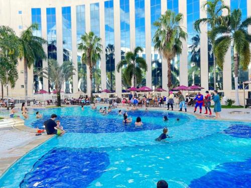 people in a swimming pool at a resort at Condominio Barretos Thermas Park - Condohotel 1242 in Barretos