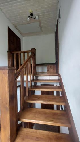 a wooden staircase in a room with a ceiling at Під Боржавою in Pilipets