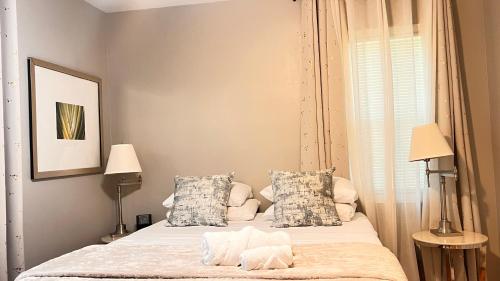 a bedroom with a bed with two pillows at 3BR Executive Stay 15 Min to ATL Airport Fast Wi-Fi Free Parking in Atlanta