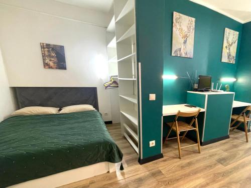 a bedroom with a bed and a desk with a computer at Апартаменти в центрі старого Львова in Lviv