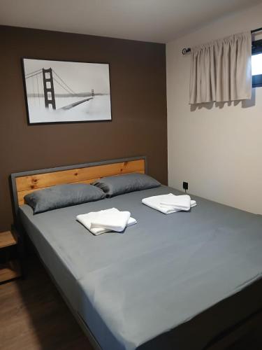 two beds in a bedroom with two towels on them at Corner Bungalow in Ulcinj
