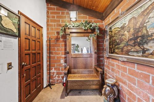 a hallway with a brick wall and a mirror at Catalina Courtyard Suites in Avalon