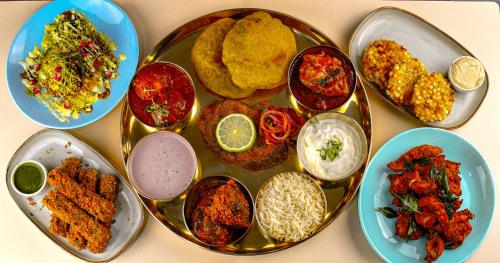 a plate of food with different types of food at The Lansbury Heritage Hotel & SPA By Sunday - Canary Wharf London in London