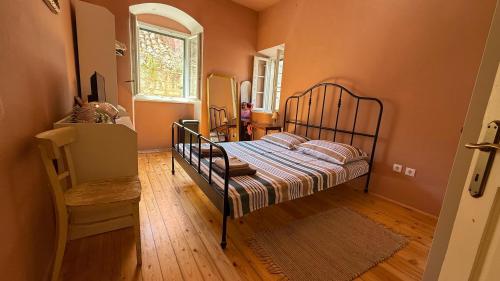 a bedroom with a bed and a table and a window at Holiday home Teraca u Babe- in the town center in Omiš