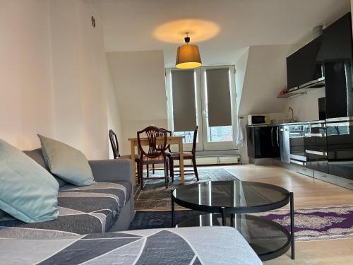 a living room with a couch and a table at Metro Apartment Linde Alle 14, 3Th 2720 Vanløse in Copenhagen