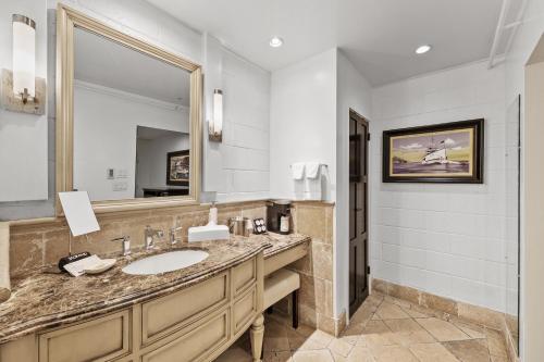 a bathroom with a sink and a mirror at Catalina Courtyard Suites in Avalon