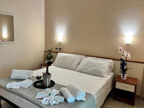 a bedroom with a bed with towels on a table at Blue Loft Hotel in Cesenatico