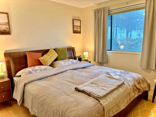 a bedroom with a large bed and a window at Departure view in Nanaimo