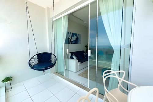 a glass house with a blue chair in a room at Desperte com o Azul do Mar na Sua Janela! in Guarujá