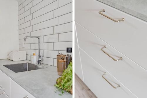 a kitchen with white subway tiles and a sink at Central apartment Eslöv! 20 km from Lund in Eslöv