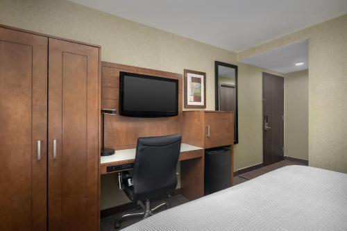 a hotel room with a desk and a television at Holiday Inn Express Manhattan Midtown West by IHG in New York