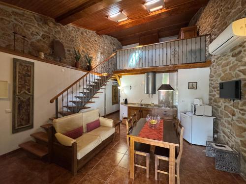 a living room with a couch and a table at Juízo Country Houses in Azevo