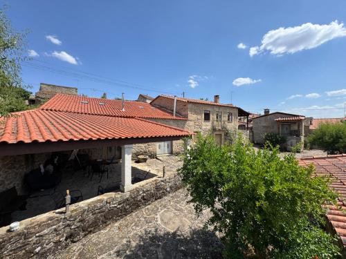 a group of buildings with a red roof at Juízo Country Houses in Azevo