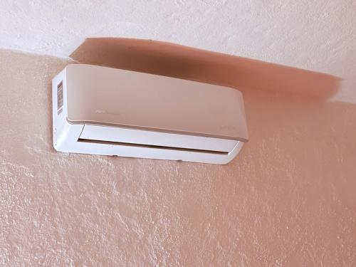 a air conditioner on the ceiling of a room at Casa Basea in Zihuatanejo