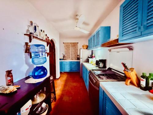 a kitchen with blue cabinets and a counter top at Casa Basea in Zihuatanejo