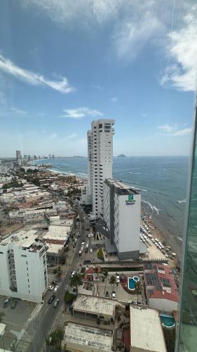 an aerial view of a city with buildings and the ocean at HOTEL TRAMONTO MAZATLAN in Mazatlán