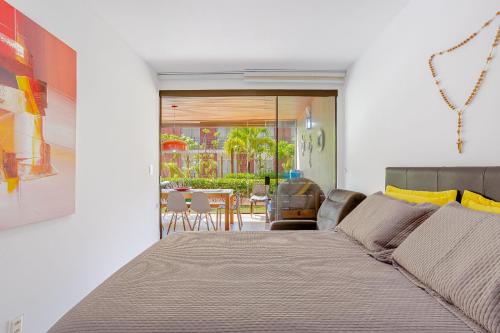 a bedroom with a bed and a dining room at IT107 Apto Pé na Areia com com 3/4 - Itacimirim in Itacimirim
