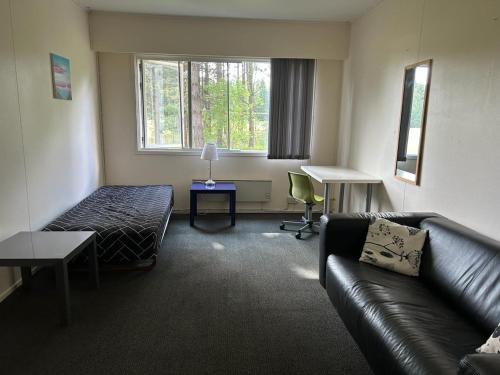 a living room with a couch and a bed at Tvind B&B in Ulfborg